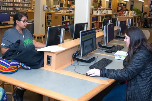 Two students sit at the computer lab in the Biddeford campus library